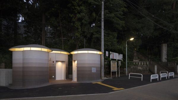 The toilets illuminate the forest at night.